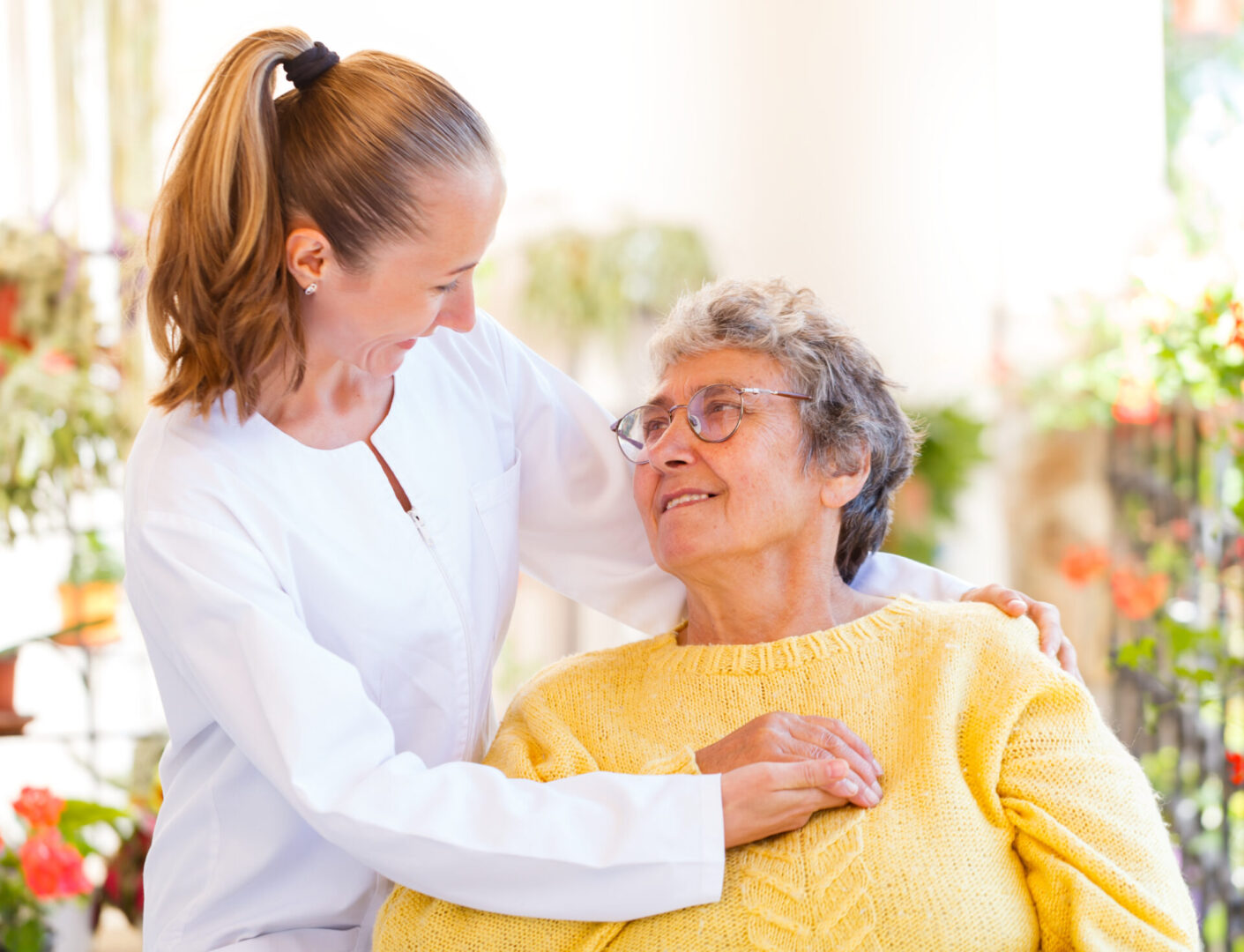 A woman is hugging an older person